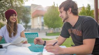 Students talking at a table